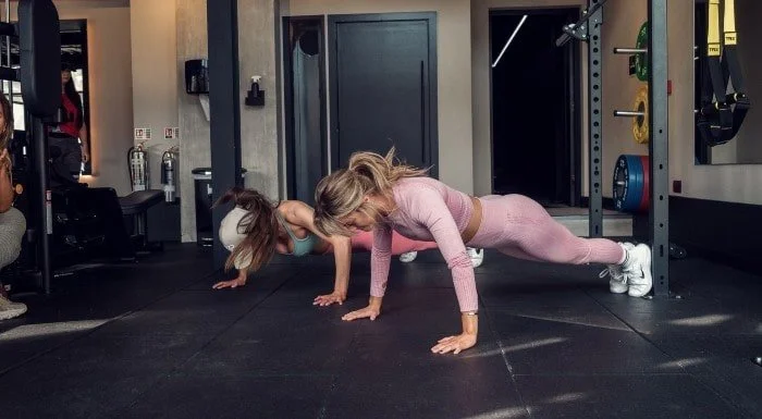 Woman performing a forearm plank on a mat